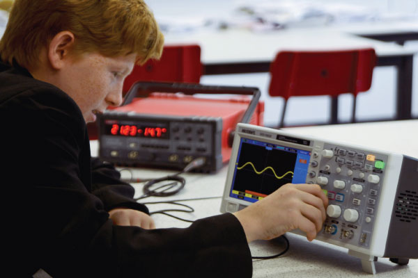 Student using Voltcraft oscilloscope